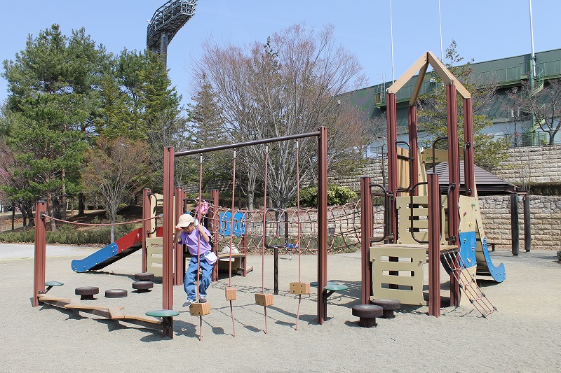 南長野運動公園の小さいお子さん向けの複合遊具で遊ぶ6歳の女の子